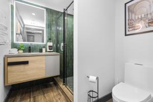 a bathroom with a shower and a sink and a toilet at 3BR3Bth Penthouse 2 Parking Spaces TD MIT Harvard in Somerville +61 photos
