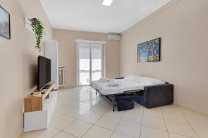a room with a bed and a flat screen tv at Casa Torino - Rho Fiera Stay in Rho
