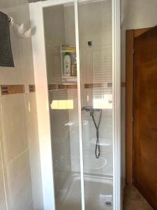 a shower with a glass door in a bathroom at Apartamento Puertu Chicu con plaza de garaje privada in Llanes +28 photos