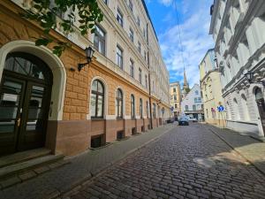 a cobblestone street in a city with buildings at Avocado Old Town 2BR Spacious Apartment near Dome Square in Rīga