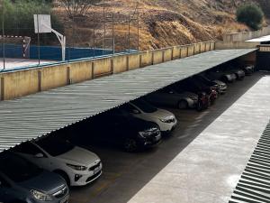 a row of cars parked in a parking lot at Superior Apartment with prepaid Parking - Malaga in Málaga