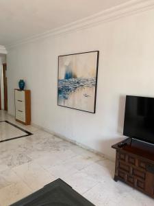 a living room with a flat screen tv on a wall at Dar sam in Tangier