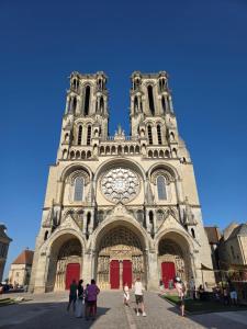 a group of people standing in front of a cathedral at L Escapade Love Room in Laon