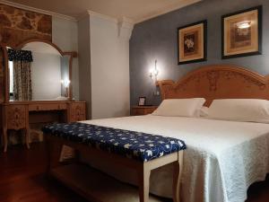 a bedroom with a large bed and a mirror at Hotel GBC Celta in A Guarda
