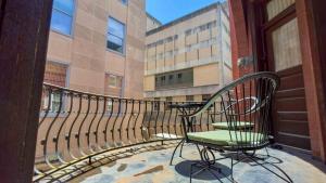 a balcony with a bench and a chair on a building at Court St Suite in Clarksburg