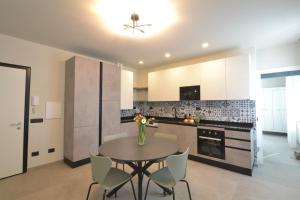 a kitchen with a table and chairs in a kitchen at CIVICO 8 Reggio Emilia in Reggio Emilia