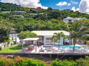 an aerial view of a house with a swimming pool at Villa SEA VIEW, 5 min from the beach, overlooking the caribbean sea, private pool in Friar's Bay