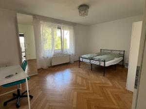 a bedroom with a bed and a wooden floor at SeeZeit Friedrichshafen in Friedrichshafen