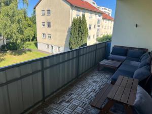 a balcony with a couch and a table at SeeZeit Friedrichshafen in Friedrichshafen +3 photos