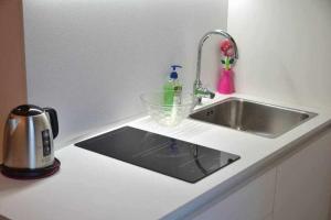 a kitchen counter with a sink next to a sink at CA MATTA luxury and relax in Noale +39 photos