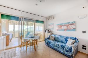 a living room with a couch and a table at Appartamenti Verde Blu in Capoliveri
