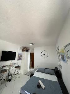 a bedroom with a bed and a clock on the wall at Seaesta holiday- Modern studio in Okrug Gornji +11 photos