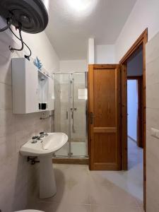 a bathroom with a sink and a shower at Icore a mare IUN T7289 in Cala Gonone
