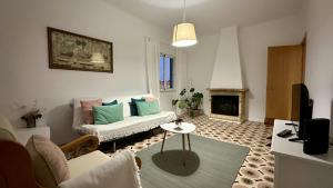 a living room with a couch and a fireplace at Casa do Monte by Check-in Portugal in Albufeira
