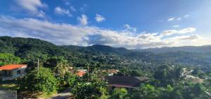 a view of a town in the mountains at Nia's Hillside Apartment - Amazing Scenery in Grande Rivière
