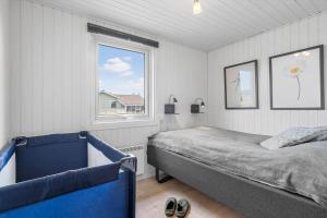 a bedroom with a bed and a window at 3390-Hvide-Sande-Sivbjerg-57 in Hvide Sande