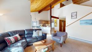 a living room with a leather couch and a chair at Bridgepoint Condo 30 in Ketchum