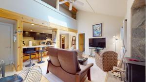 a living room with a couch and chairs and a kitchen at Crestview Condo 25 in Ketchum