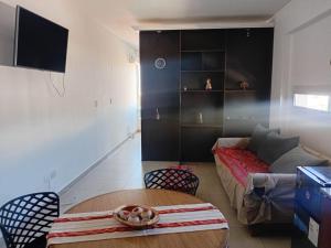 a living room with a couch and a table at Paseo de los Poetas in Salta