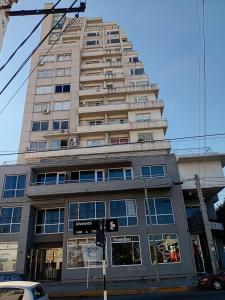 a tall building with a street sign in front of it at Paseo de los Poetas in Salta