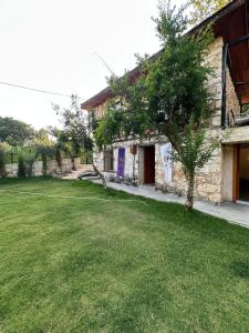 a house with a grass yard next to a building at La Dimora Villas in Kaş +33 photos