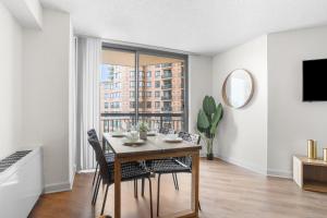 a dining room with a table and chairs and a window at Pentagon City Escape - Contemporary & Comfy in Arlington +12 photos