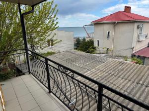 a balcony with a black railing and a building at Rumb116 in Odesa