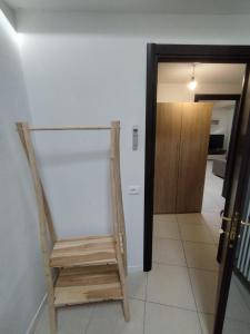 a wooden chair sitting in a hallway next to a door at Le Torri Loft, exclusive comfort in the city center in Forlì