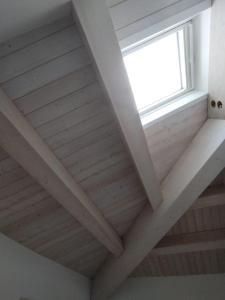 a window in a room with a wooden ceiling at Le Torri Loft, exclusive comfort in the city center in Forlì