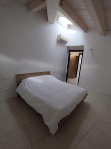 a bedroom with a white bed in a white wall at Le Torri Loft, exclusive comfort in the city center in Forlì