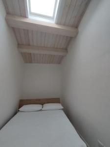 a white room with a bed and a window at Le Torri Loft, exclusive comfort in the city center in Forlì +9 photos