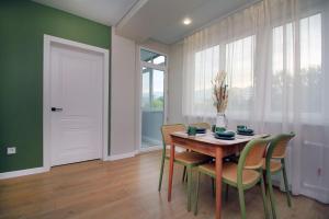 a dining room with a wooden table and chairs at Center Almaty in Almaty +4 photos
