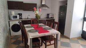 a kitchen with a table with a vase of flowers on it at Casa de Pueblo in Martos