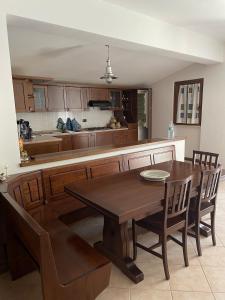 a kitchen with a wooden table and a kitchen counter at Holiday Home Tenuta Santella in Gildone