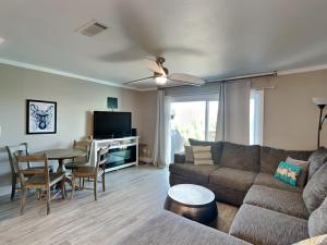 a living room with a couch and a table at Coconuts Beach House in Pensacola Beach