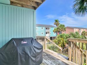 a view of a deck with a trash can on it at Coconuts Beach House in Pensacola Beach