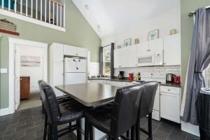 a kitchen with a table and chairs in it at The King Eider - 24 Meadow View in Cherry Valley +69 photos