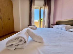 a bedroom with a bed with a towel on it at Conca Degli Dei in Paestum +94 photos