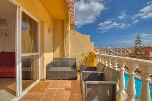 balcón de una casa con sillas y piscina en LANN Isis, en Arona