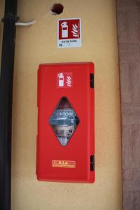 a red mail box on the side of a wall at Affittacamere La Madonnina in San Giovanni Rotondo +63 photos