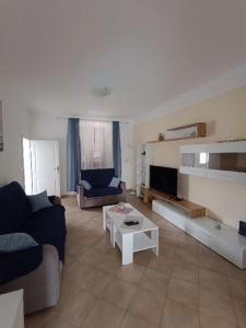 a living room with a couch and a table at Holiday Home Latin in Peruški
