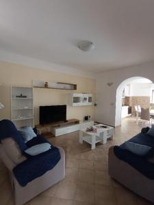 a living room with two couches and a fireplace at Holiday Home Latin in Peruški