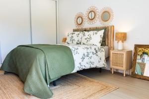 a bedroom with a bed and a mirror on the wall at Aurora do Furadouro in Ovar +17 photos