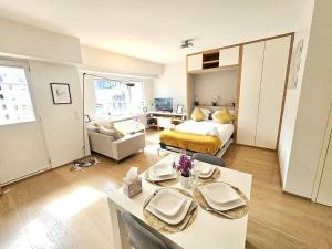 a living room with a bed and a dining table at Beautiful studio in Central Luxembourg in Luxembourg