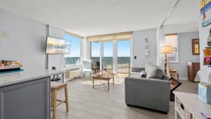 a living room with a view of the ocean at Gulf Views & Sunsets Estero Beach Tennis 206c in Fort Myers Beach