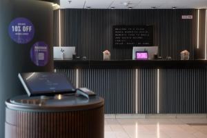 a hotel lobby with a counter with a laptop on it at Radisson Blu Hotel Dortmund in Dortmund +210 photos