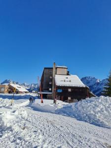 ein schneebedecktes Gebäude auf einer schneebedeckten Piste in der Unterkunft La Tana della Volpe, Falcade - BL in Falcade