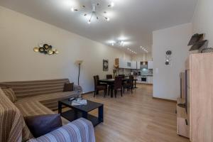 a living room with a couch and a table at Vasilis Family House in Ágios Rókkos