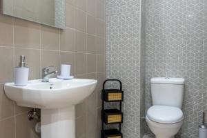 a bathroom with a sink and a toilet at Vasilis Family House in Ágios Rókkos +20 photos