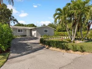 a house with palm trees and a driveway at Villa Luxe 4BD 3BR Spacious Villa Heated Pool in Boca Raton